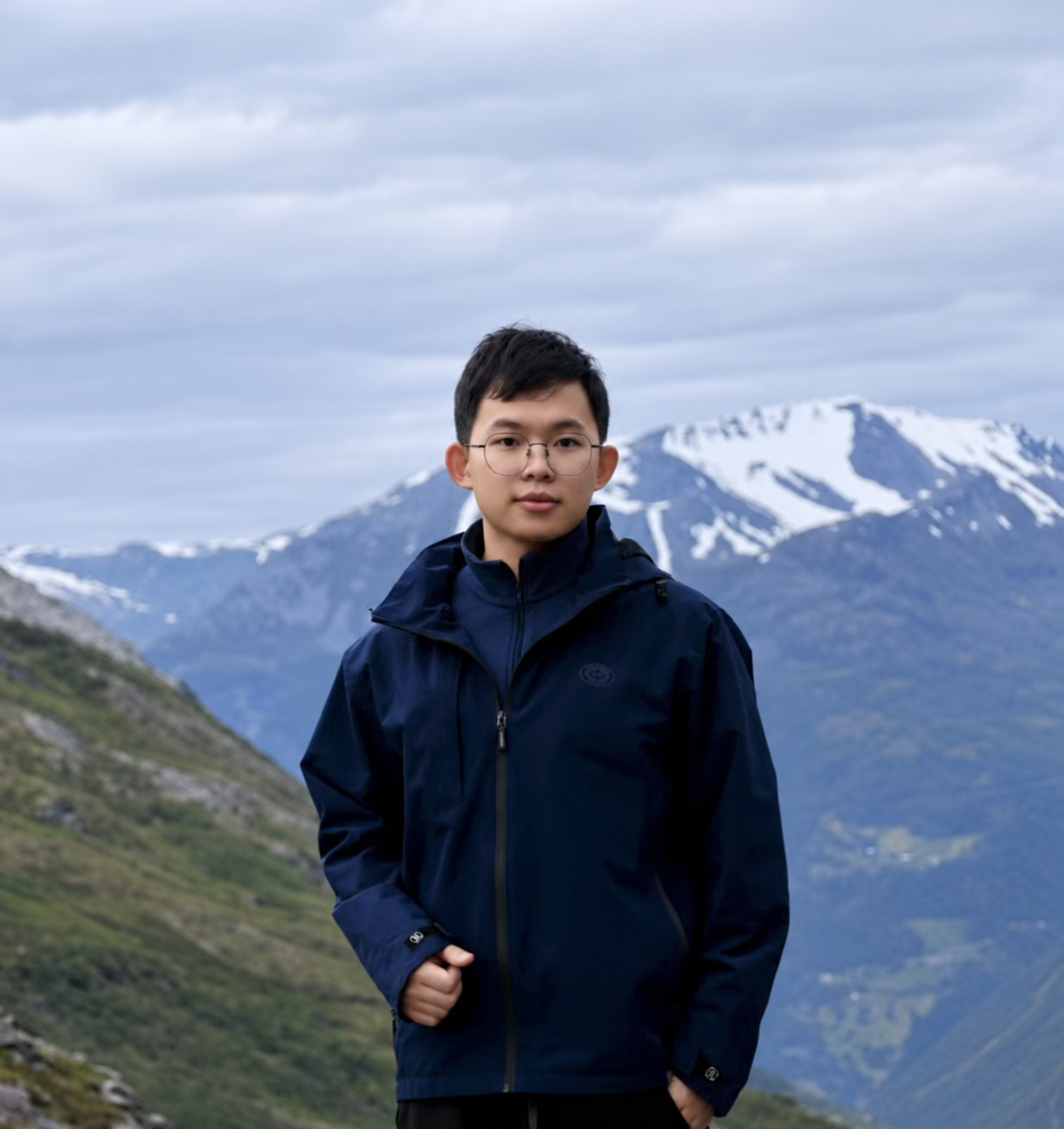 Guangba Yu standing in front of mountains